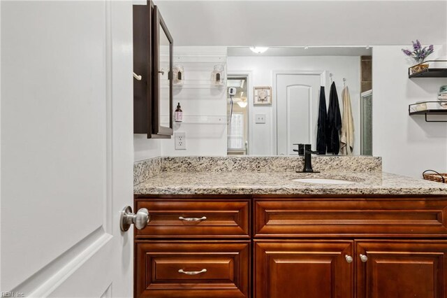 bathroom featuring vanity and a shower with shower door