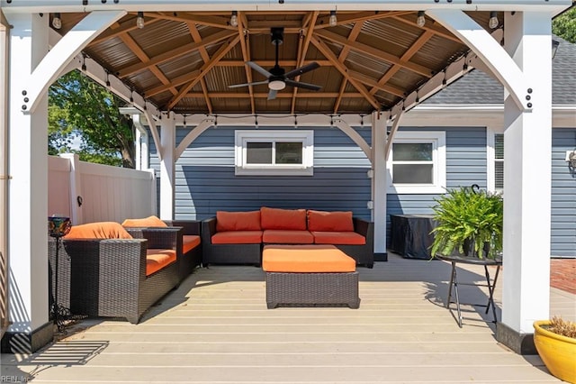 deck featuring a gazebo, a ceiling fan, outdoor lounge area, and fence