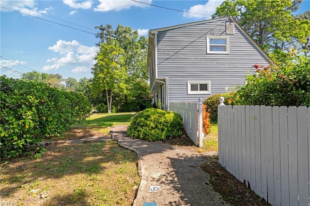 view of side of home featuring fence