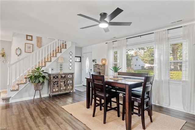 dining area featuring ceiling fan, stairs, baseboards, wood finished floors, and visible vents