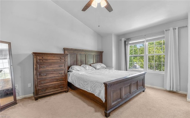 bedroom with light colored carpet, a ceiling fan, baseboards, and lofted ceiling