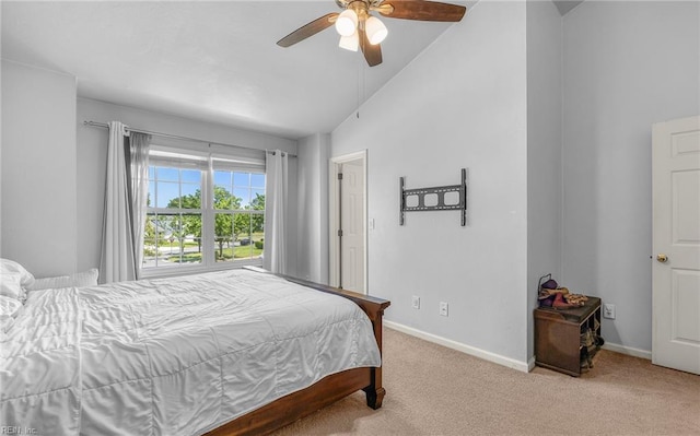 bedroom featuring baseboards, a ceiling fan, vaulted ceiling, and light colored carpet