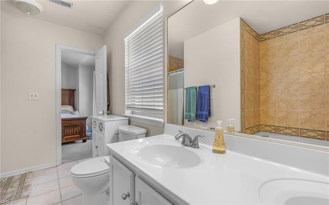 full bath featuring double vanity, toilet, a shower with shower curtain, tile patterned floors, and a sink