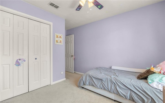 bedroom featuring ceiling fan, visible vents, baseboards, a closet, and carpet