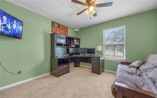 office area featuring ceiling fan, light colored carpet, and baseboards