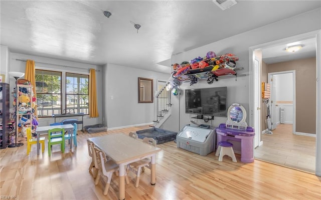 playroom featuring visible vents and wood finished floors