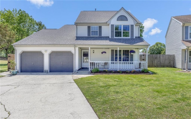 traditional-style house featuring a front lawn, fence, covered porch, concrete driveway, and an attached garage
