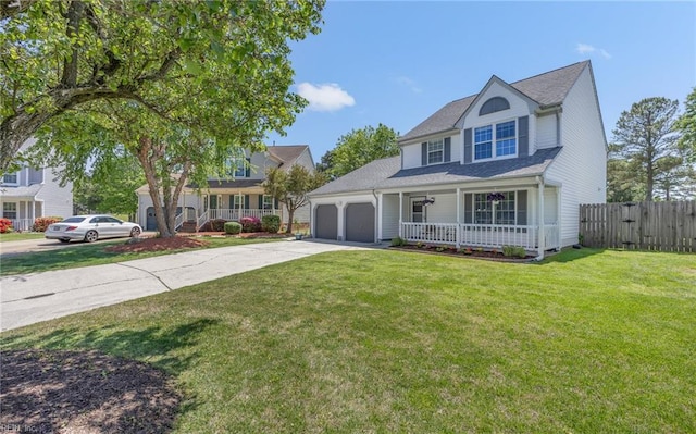 traditional-style home with covered porch, a front yard, fence, concrete driveway, and an attached garage