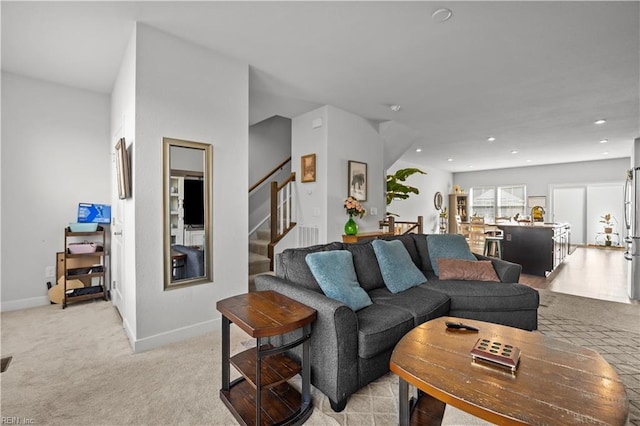 living area with light colored carpet, stairs, baseboards, and recessed lighting