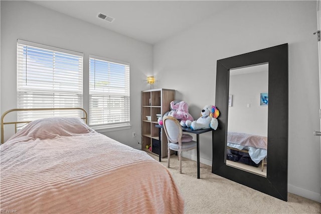 carpeted bedroom featuring baseboards, visible vents, and multiple windows