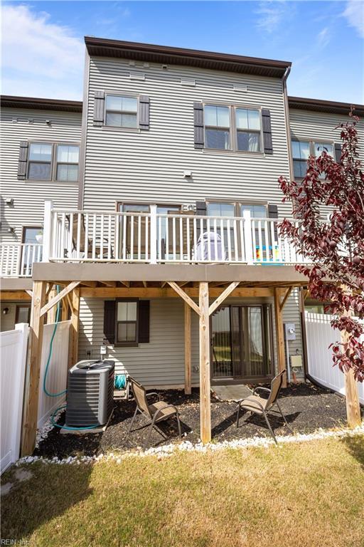 rear view of property with a yard, fence, central AC, and a deck