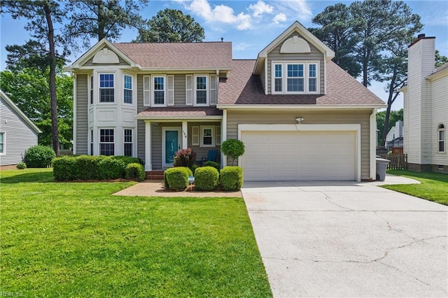 view of front of home featuring concrete driveway, roof with shingles, an attached garage, and a front yard
