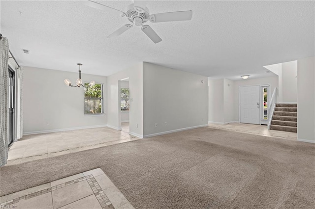 1615 Colonnade Cres, Virginia Beach, VA 23451 - unfurnished living room with light tile patterned floors, a textured ceiling, a chandelier, a ceiling fan, and stairs