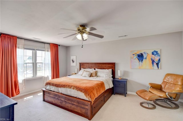 carpeted bedroom featuring visible vents, a ceiling fan, and baseboards