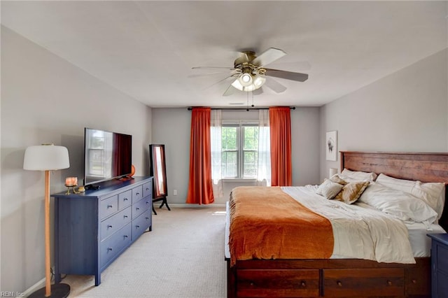 bedroom featuring a ceiling fan, baseboards, and light colored carpet