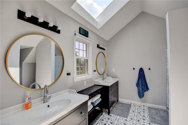 full bathroom featuring a sink, two vanities, and vaulted ceiling with skylight