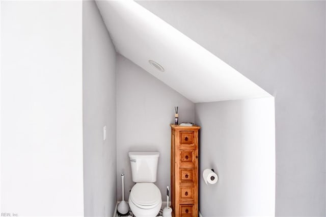 bathroom with toilet and lofted ceiling