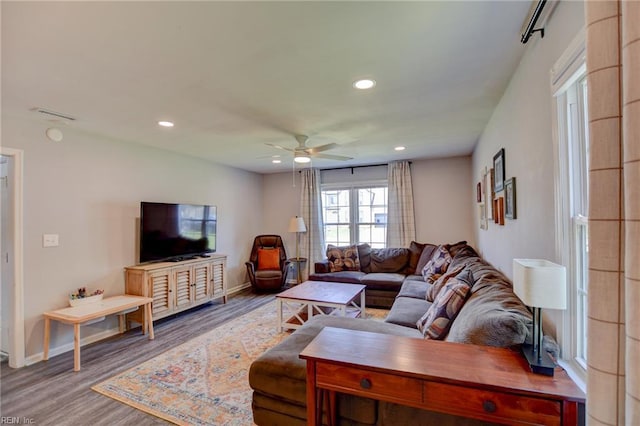 living area featuring baseboards, a ceiling fan, recessed lighting, and wood finished floors