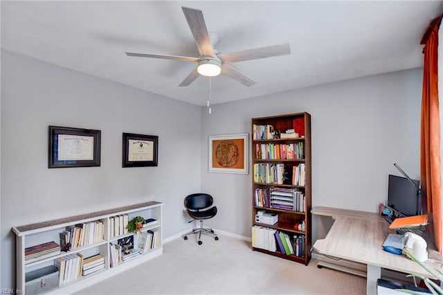 home office featuring carpet flooring, ceiling fan, and baseboards