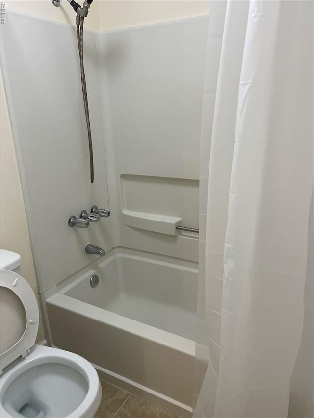 bathroom with tile patterned floors, toilet, and shower / tub combo