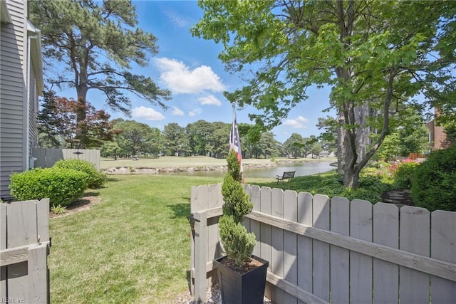 view of yard with fence and a water view