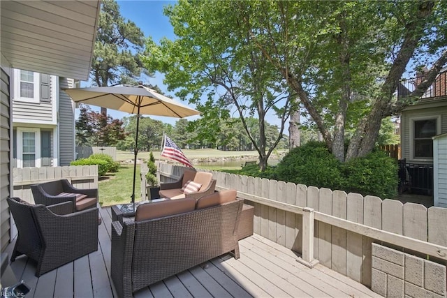 wooden deck with outdoor lounge area and a fenced backyard