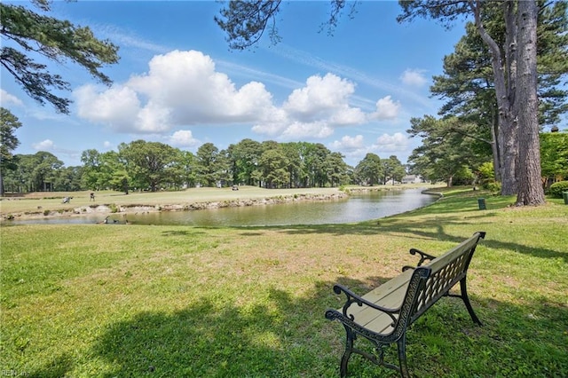exterior space featuring a lawn and a water view