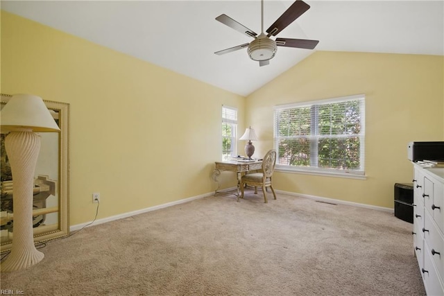 carpeted home office featuring a ceiling fan, baseboards, and vaulted ceiling