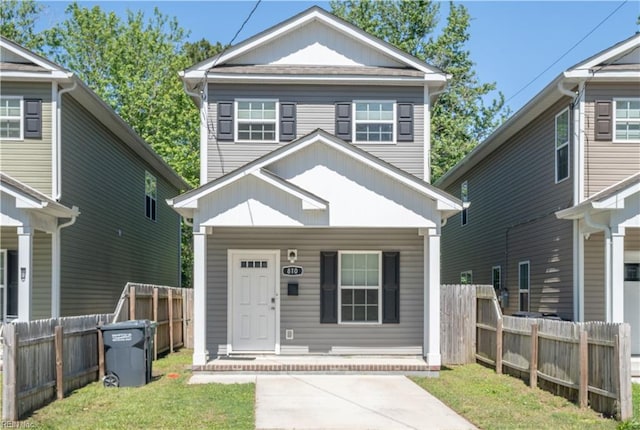 view of front of house with covered porch, fence, and board and batten siding