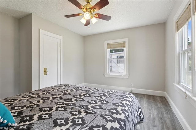 1312 E Norcova Dr, Norfolk, VA 23502 - bedroom with a textured ceiling, baseboards, a ceiling fan, and wood finished floors