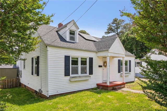 1312 E Norcova Dr, Norfolk, VA 23502 - view of front of house featuring roof with shingles, fence, solar panels, and a front yard