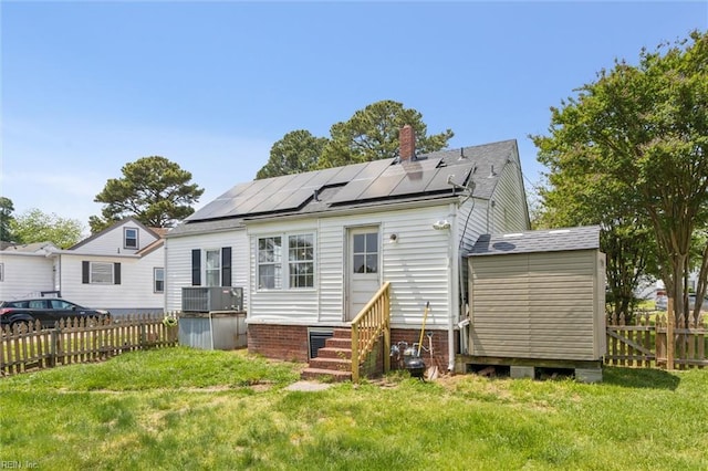 1312 E Norcova Dr, Norfolk, VA 23502 - rear view of house featuring solar panels, a yard, a chimney, and entry steps