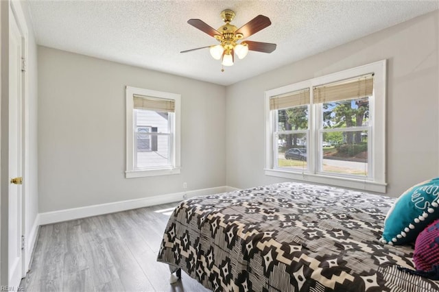 1312 E Norcova Dr, Norfolk, VA 23502 - bedroom with baseboards, a ceiling fan, a textured ceiling, and wood finished floors