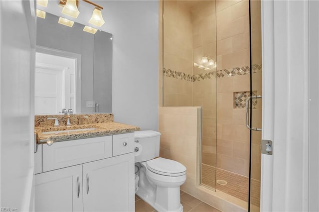bathroom with vanity, tile patterned flooring, a stall shower, and toilet
