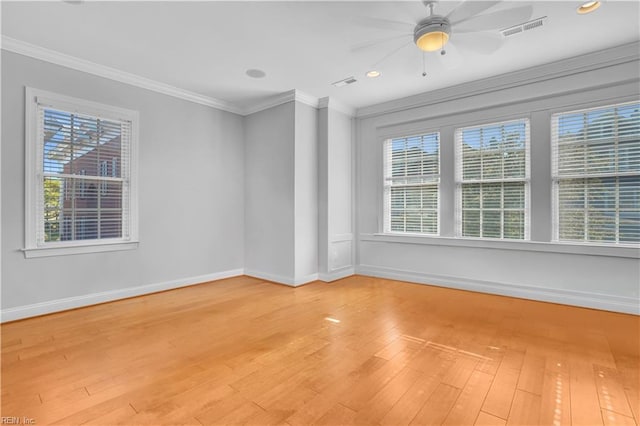 unfurnished room featuring baseboards, visible vents, ornamental molding, and light wood finished floors