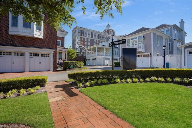 exterior space featuring decorative driveway, an attached garage, and cooling unit
