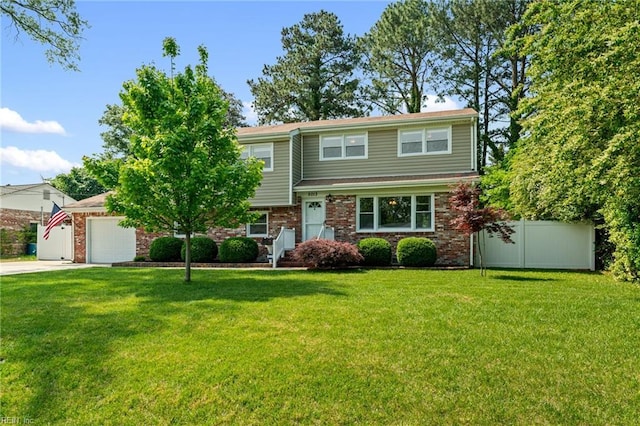 5013 Finn Rd, Virginia Beach, VA 23455 - view of front facade featuring fence, an attached garage, a front lawn, brick siding, and driveway