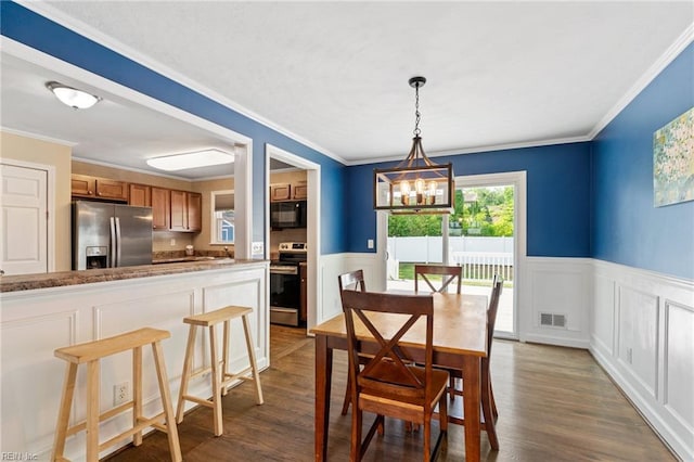 5013 Finn Rd, Virginia Beach, VA 23455 - dining area featuring visible vents, dark wood-style flooring, a wainscoted wall, and an inviting chandelier