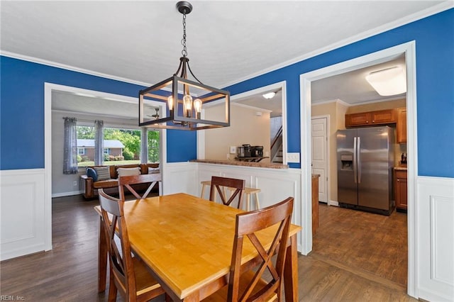 5013 Finn Rd, Virginia Beach, VA 23455 - dining space featuring an inviting chandelier, wainscoting, dark wood finished floors, ornamental molding, and stairway