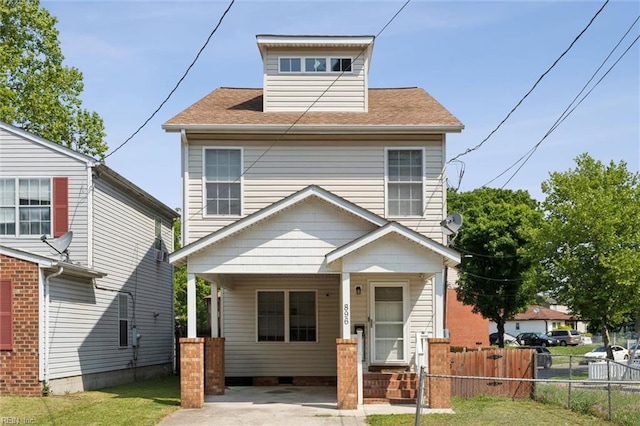 traditional style home with roof with shingles, fence, and a carport