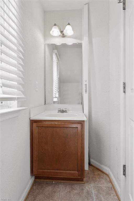 bathroom featuring vanity and baseboards