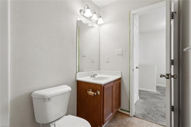 bathroom with tile patterned floors, vanity, and toilet