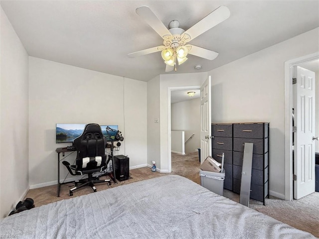 carpeted bedroom with baseboards and a ceiling fan