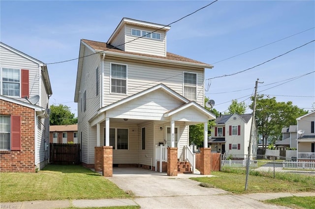 traditional style home with fence, a carport, driveway, and a front lawn