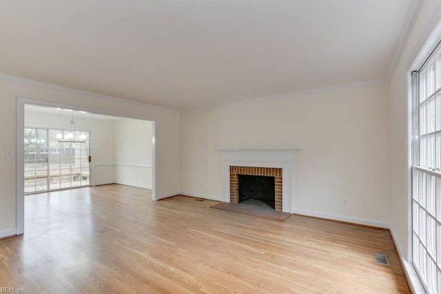 106 Running Man Trl, Yorktown, VA 23693 - unfurnished living room featuring crown molding, visible vents, light wood finished floors, and a notable chandelier