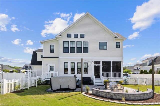 2245 Chamberino Dr, Virginia Beach, VA 23456 - rear view of house with a sunroom, an outdoor fire pit, fence, and a lawn