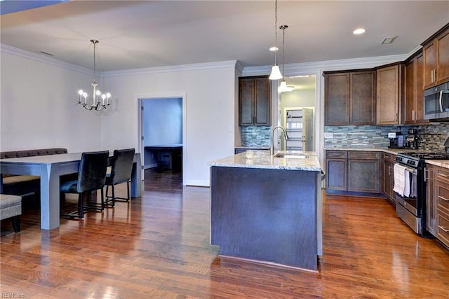 kitchen with backsplash, dark brown cabinetry, stainless steel appliances, and light stone countertops