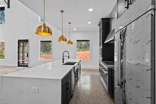 kitchen with wall chimney range hood, high end stainless steel range oven, finished concrete floors, baseboards, and dark cabinetry