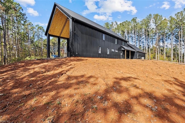 view of property exterior with an outbuilding