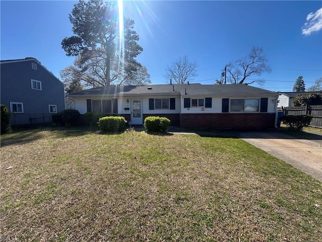 ranch-style house with brick siding, fence, and a front yard